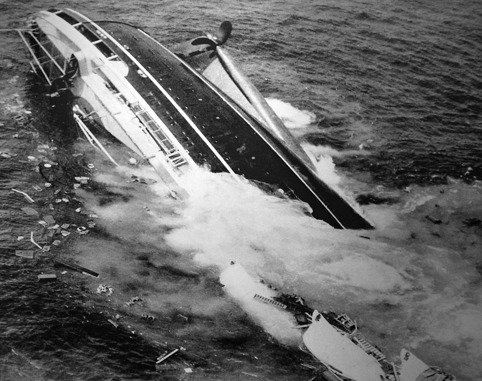 Photo of the SS Andrea Doria half submerged after colliding with the Swedish ship Stockholm off the coast of Nantucket Island, Massachusetts in July 1956. When Trask won the 1957 Pulitzer Prize for Photography for his photos of the sinking ship, this image was cited as the "key photograph" in the sequence.