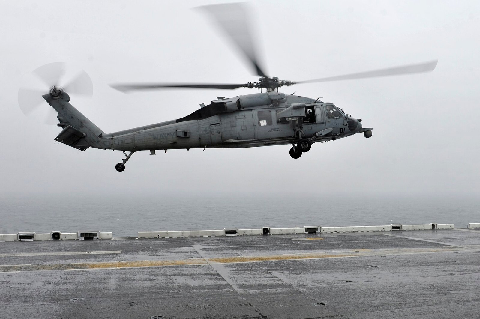 EAST CHINA SEA (April 17, 2014) An MH-60S Sea Hawk helicopter, assigned to Helicopter Sea Combat Squadron (HSC) 25, lands on the flight deck of the forward-deployed amphibious assault ship USS Bonhomme Richard (LHD 6) after conducting search and rescue operations. Sailors and Marines onboard Bonhomme Richard are conducting search and rescue operations as requested by the Republic of Korea navy near the scene of the sunken ferry Sewol in the vicinity of the island of Jindo. (U.S. Navy photo by Mass Communication Specialist 2nd Class Adam D. Wainwright/Released)